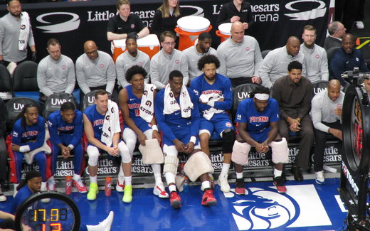Players sitting on a team bench during an NBA game