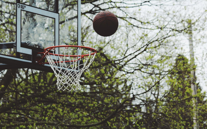 A basketball dropping through the net